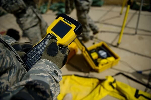 U. S. Air Force Airman uses a satellite base station to collect data on terrain features