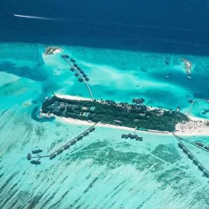Amazing bird eyes view in Maldives from plane or drone. Luxury resort hotel water villas bungalows. Summer vacation holiday landscape destination