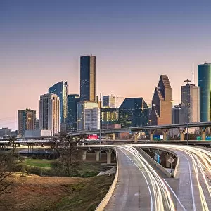 Houston, Texas, USA downtown city skyline and highway at dusk